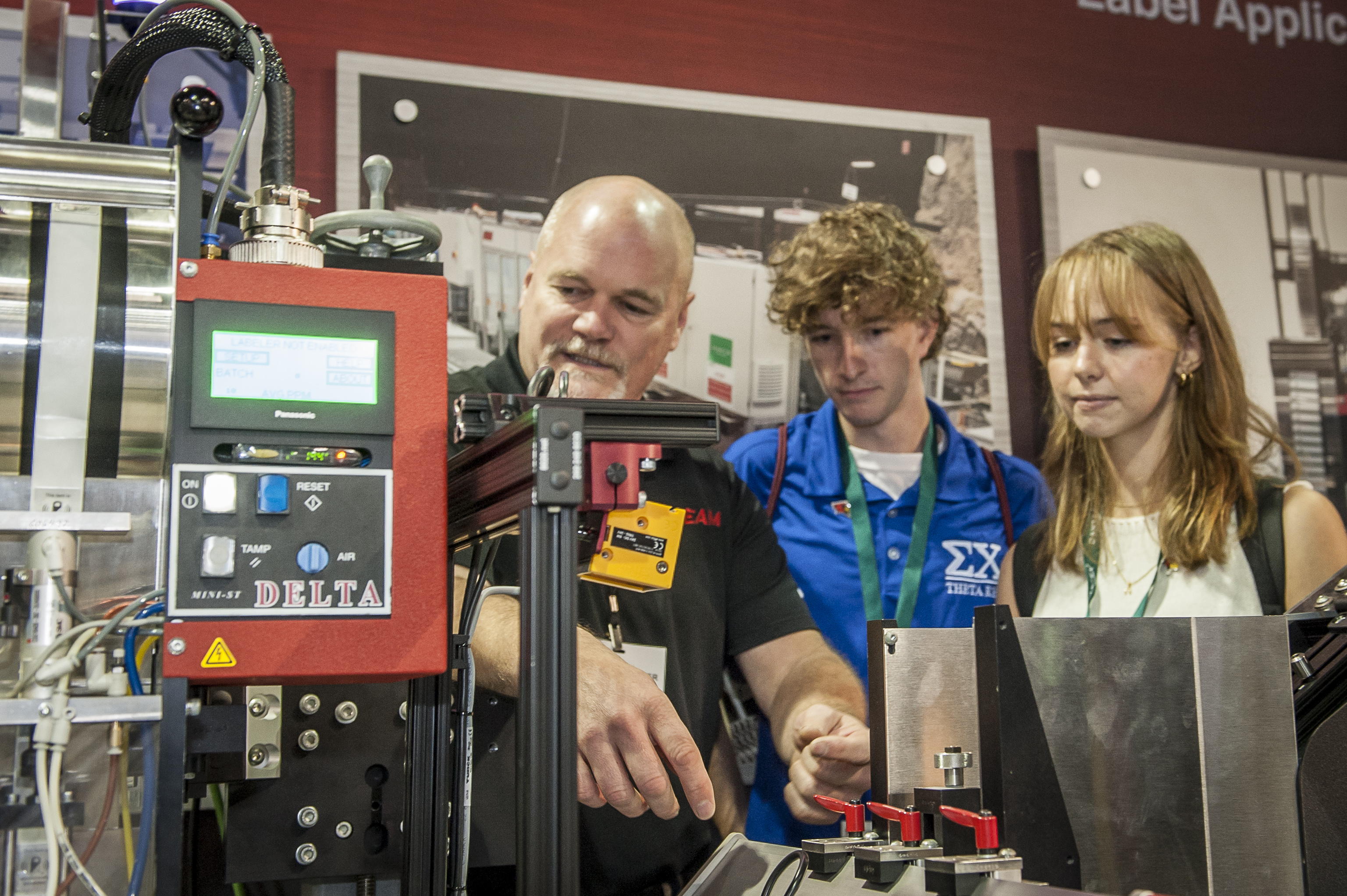 People looking at machine